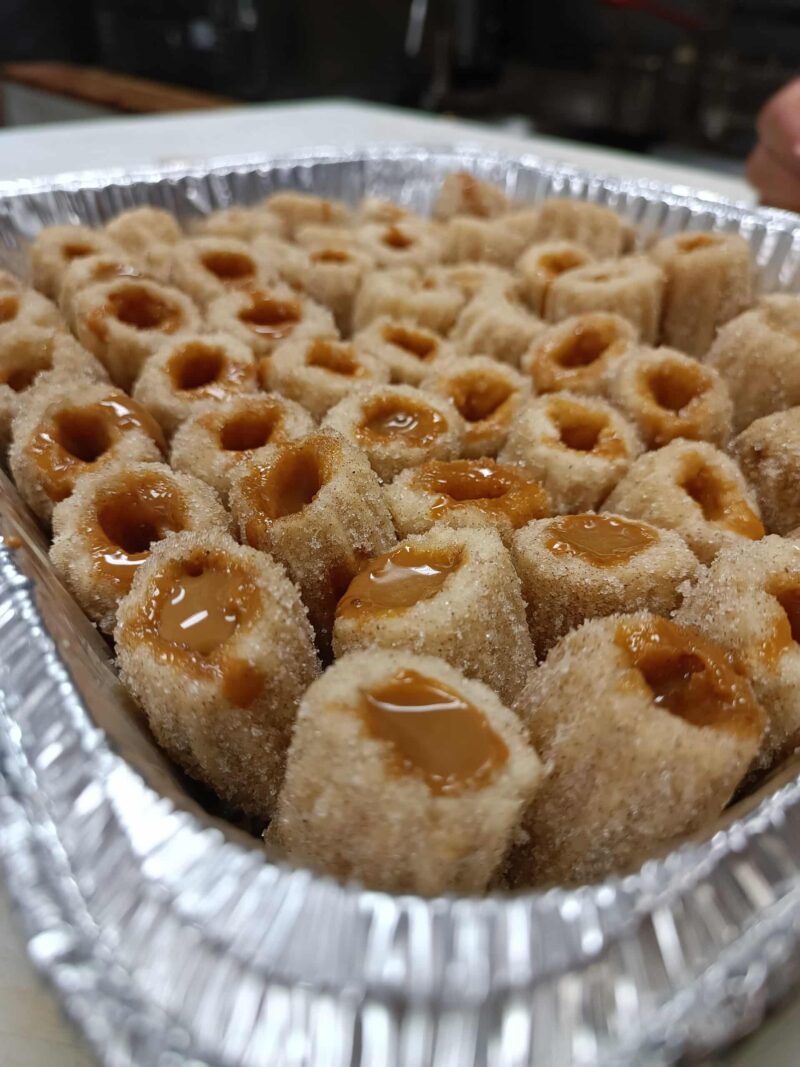 Tray of Filled Churros with cinnamon sugar and filled with your choice of dulce de leche, dark chocolate or coffee cream.