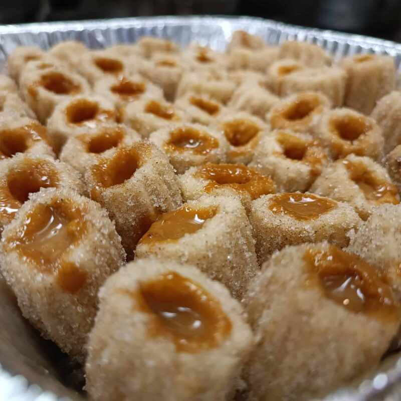 Tray of Filled Churros with cinnamon sugar and filled with your choice of dulce de leche, dark chocolate or coffee cream.