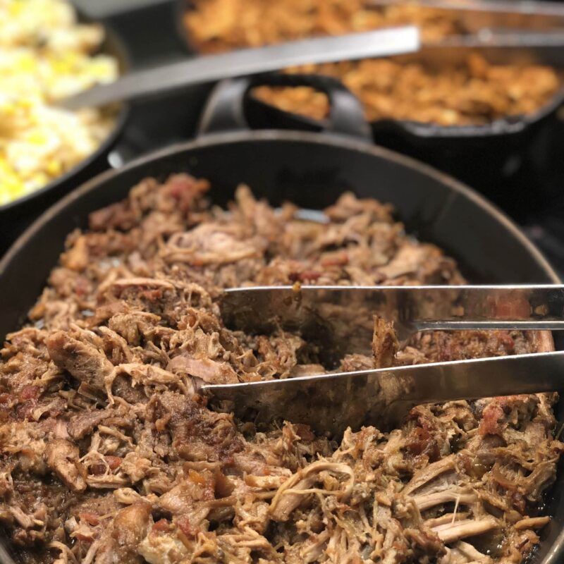 Tray of Pork mechada, with tomato, black pepper & spices.