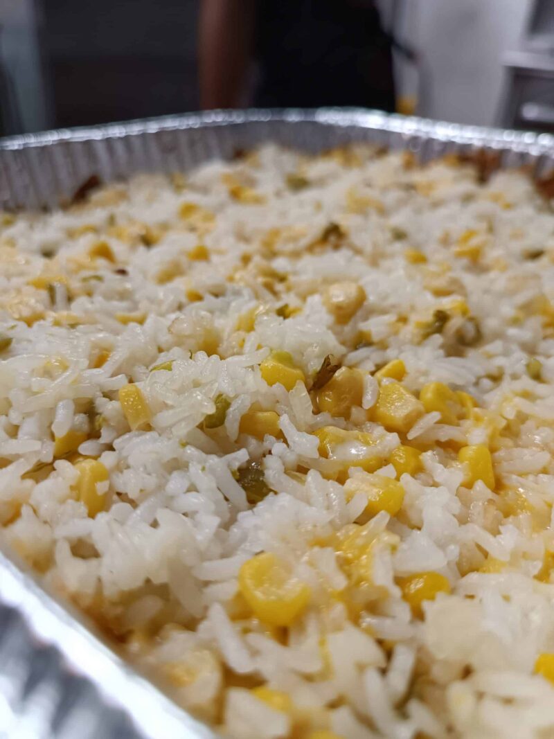 El Merkury's iconic Baked Cheese Rice Tray, featuring rice, corn, jalapenos and 3 types of cheese.