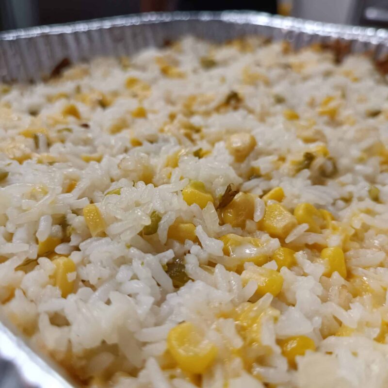 El Merkury's iconic Baked Cheese Rice Tray, featuring rice, corn, jalapenos and 3 types of cheese.