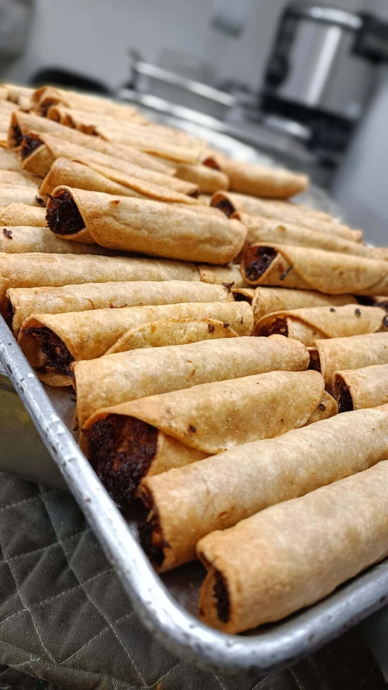 Guatemalan taquito tray contains taquitos filled with veggies, meat or cheese.