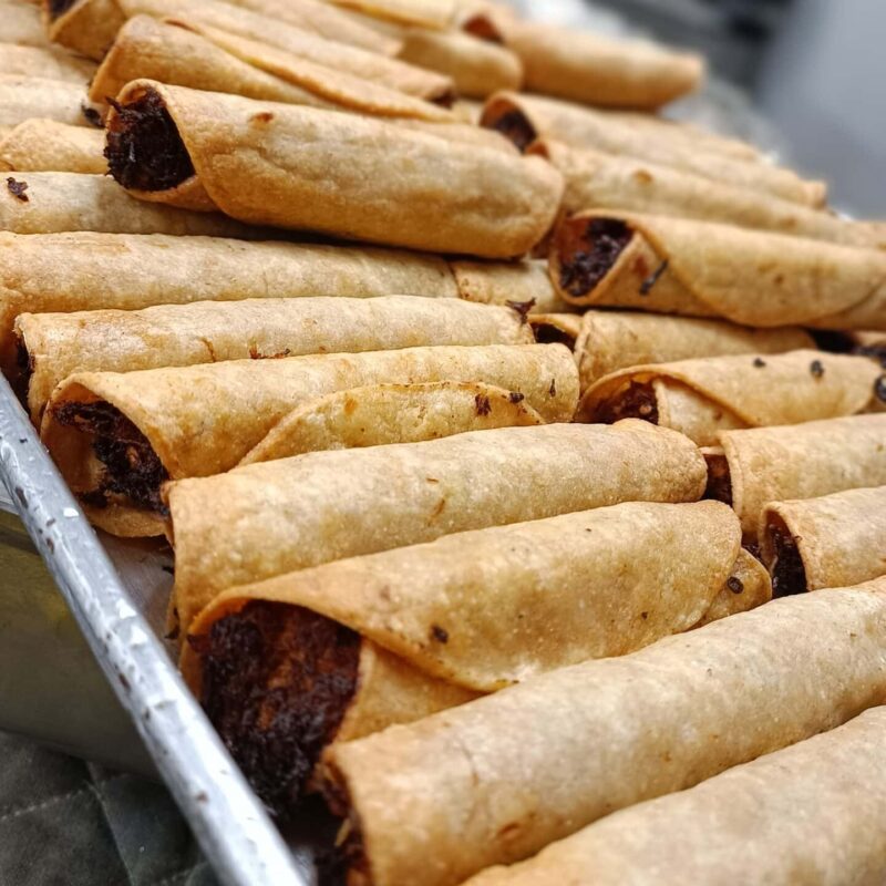 Guatemalan taquito tray contains taquitos filled with veggies, meat or cheese.